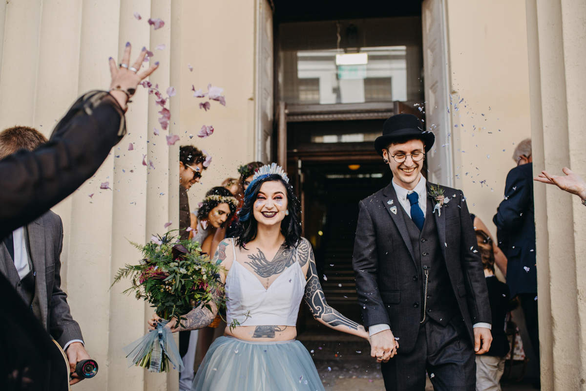 alternative bride and groom in confetti aisle at brighton wedding
