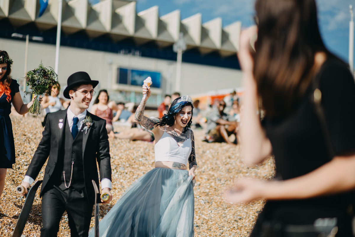 alternative tattoo skater couple with ice cream on brighton beach